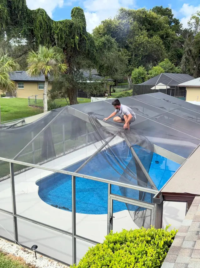 My Screen Repair technician re-screening a residential pool cage in Lakeland, Florida